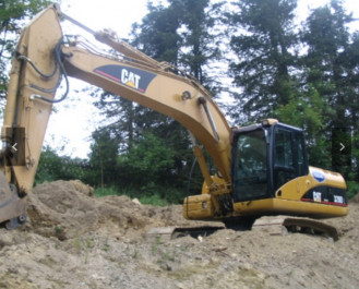 Bagger CAT 320 DL mit Hydraulikhammer
